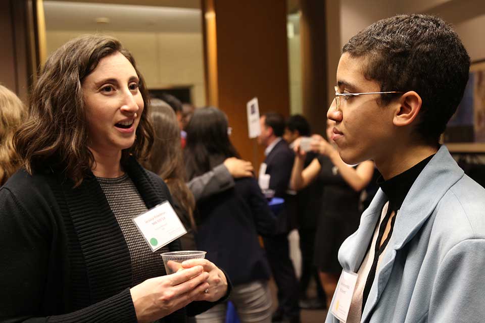alumna talking to student