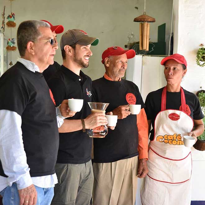 Brian Schon, MPP/MBA'11, with people holding coffee cups and a coffee pour over